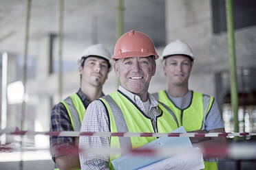 Portrait of three male construction workers wearing hardhats - AJOF01196