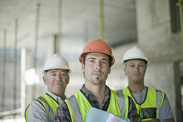 Portrait of three male construction workers wearing hardhats - AJOF01197