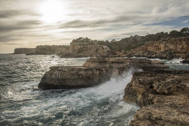 Sun shining over rough coastal cliffs of Mallorca - JMF00560