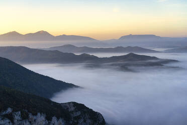 Fog covering mountains during sunrise at Furlo Gorge, Marche, Italy - LOMF01236