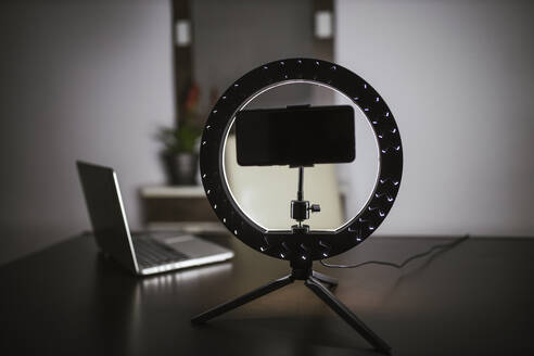 Smart phone with LED ring light and laptop on table - LJF02095