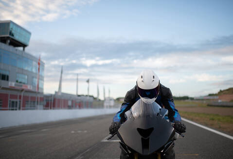 Motorcyclist ready to ride on track during race - CAVF93629