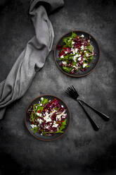 Studio shot of two plates of vegetarian salad with lentils, arugula, feta cheese, radicchio and bell pepper - LVF09090