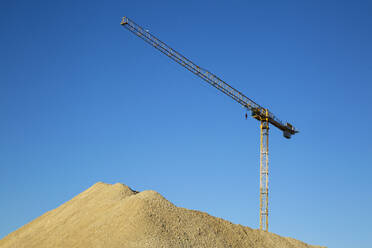 Germany, Bavaria, Munich, Construction crane against blue sky - MAMF01673