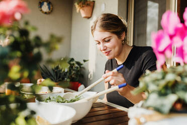 Young woman serving salad - CUF57923