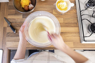 Woman stirring cheesecake filling - WPEF04209