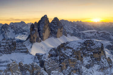 Sunset over Tre Cime Di Lavaredo, Monte Paterno and Cristallo during a snowy autumn, Sesto Dolomites, South Tyrol, Italy, Europe - RHPLF19361