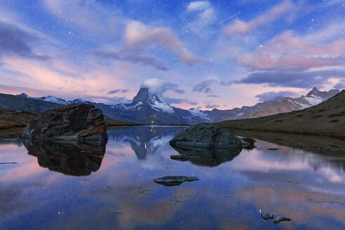 Glowing stars over Matterhorn mirrored in lake Stellisee at dusk, Zermatt, Valais canton, Switzerland, Europe - RHPLF19364