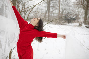 Young Redhead Girl In Flowing Red Dress In Forest With Snowfall. Photograph  by Cavan Images - Fine Art America