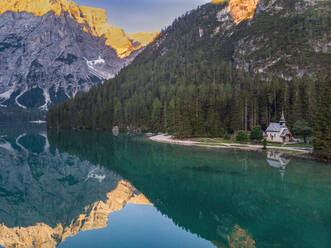 Reflection of Croda del Becco mountain in lake Pragser Wildsee during sunrise at Dolomites, Alto Adige, Italy - LOMF01250