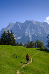 Female hiker following mountain trail toward Zugspitze mountain - LBF03461