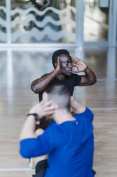 Male athletes exercising in health club - EBBF02746