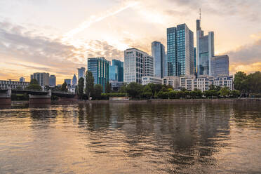 Germany, Hesse, Frankfurt, Bank of river Main and Mainhattan skyline at sunset - TAMF02905