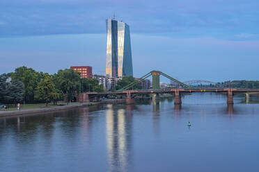 Germany, Hesse, Frankfurt, River Main and Ignatz-Bubis-Bridge at dusk with European Central Bank in background - TAMF02910