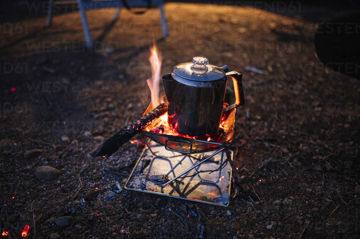 https://us.images.westend61.de/0001535821pw/kettle-on-camping-stove-at-night-JCMF01934.jpg