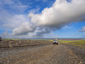 Clouds over off-road car driving along remote dirt road at Myrdalsjokull icecap - LAF02692