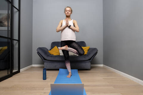 Teen girl doing yoga at home - a Royalty Free Stock Photo from