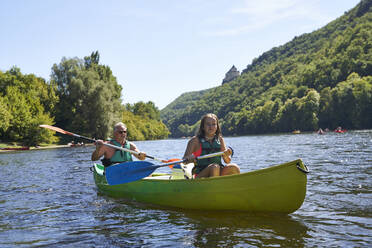 Mädchen mit Vater beim Kanufahren auf dem See in den Ferien - AUF00588