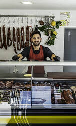 Man working at the butcher's shop - CAVF93730