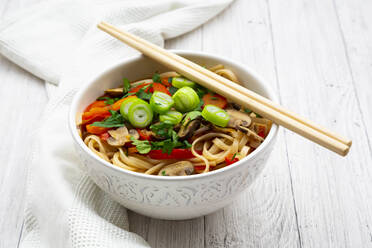 Asian noodle soup with rice noodles, bell pepper, mushrooms, spring onions, coriander and carrots - LVF09113