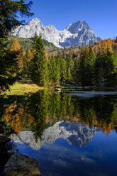 Scenic view of Lake Alm with Oberhofalm mountain in background - LBF03470