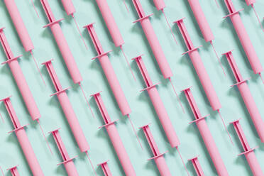 Pink syringes on green background - ECF02030