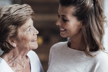 Happy grandmother and young woman looking at each other - GUSF05533