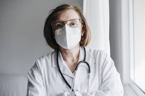 Senior medical professional with protective face mask in hospital - EBBF02817
