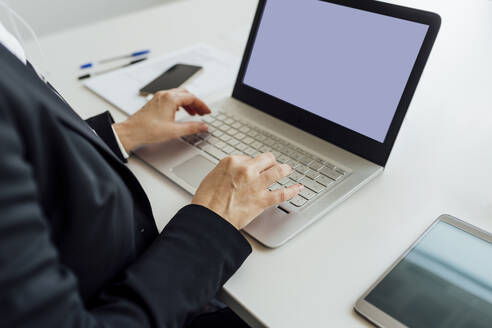 Mature businesswoman using laptop at desk - MEUF02186