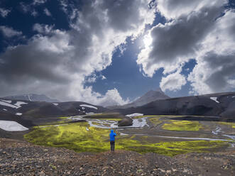 Mid adult man looking at view while standing on land at Fjallabak Nature Reserve - LAF02707