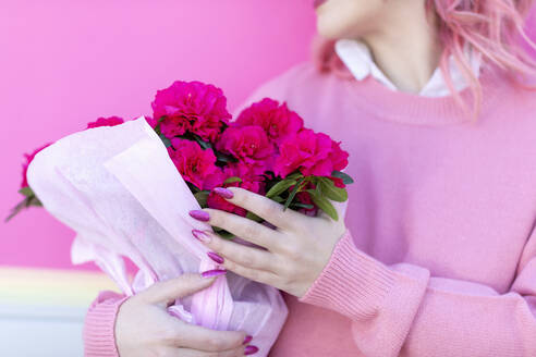 Woman holding pink Azalea flowers - EIF00726