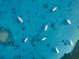 North Male Atoll, Huraa island, Aerial view of boats on blue water - KNTF06198