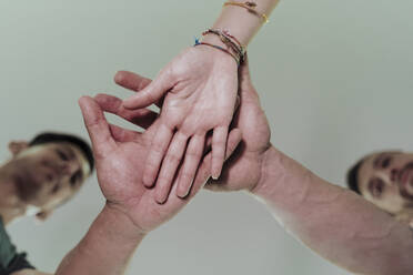 Friends with stacked hands in gym - EBBF02870