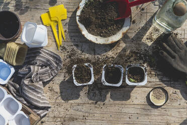 Mud and gardening equipment on table during springtime - SKCF00730