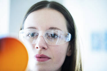 Female scientist examining medical sample in laboratory - SGF02801