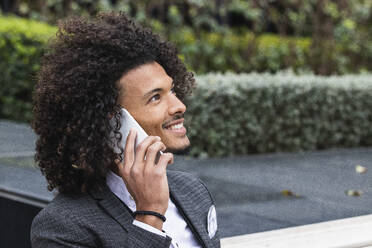Smiling businessman talking on smart phone - PNAF01266