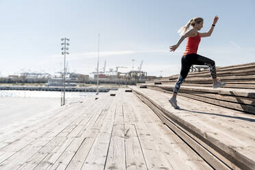 Young woman running on steps - AMPF00158