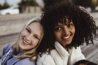 Portrait of smiling female friends on pier - MASF22749