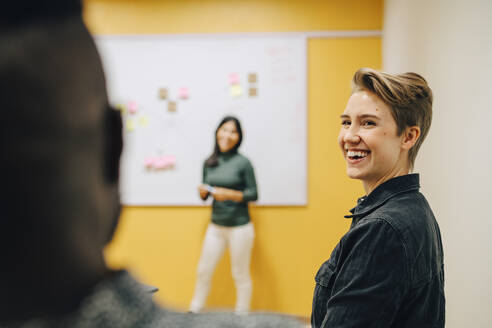 Smiling business people discussing in board room at office - MASF22936