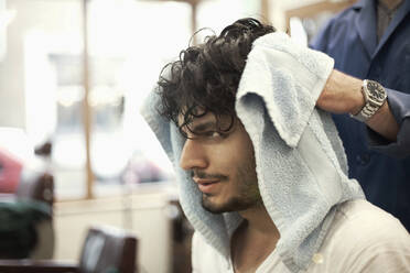Hands of barber washing hair of male customer - AJOF01292