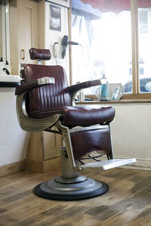 Empty chair inside barber shop - AJOF01301