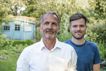 Father and son in garden during sunny day - GUSF05713