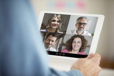 Business people on video conference through digital tablet in office - PSBHF00007