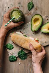Hand holding a healthy panini of turkey and avocado - ADSF22508