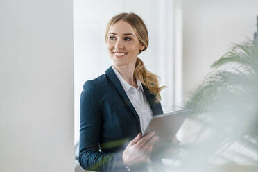 Smiling businesswoman contemplating at office - DIGF15085