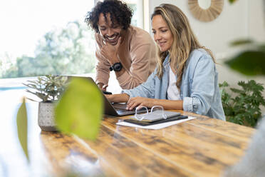 Man and woman working and looking at laptop together - SBOF03702