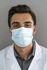 Male healthcare worker wearing protective face mask during COVID-19 - GIOF12210