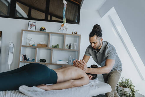 Female patient receiving spine massage in medical practice - MFF07813