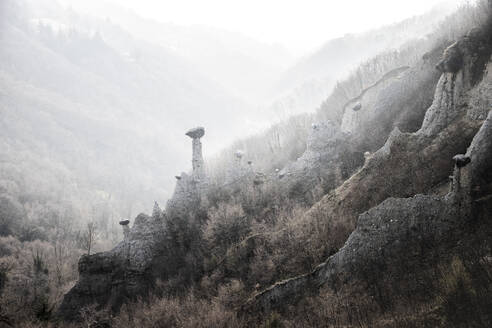 Earth pyramids of Zone in the fog, Zone, Brescia province, Lombardy, Italy, Europe - RHPLF19444