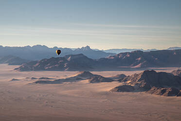 Rocky mountains, aerial view with hot air balloon flying over it, Namibia, Africa - RHPLF19497